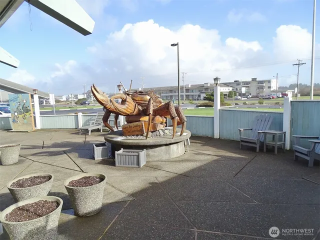 a living room with lots of furniture and kitchen view