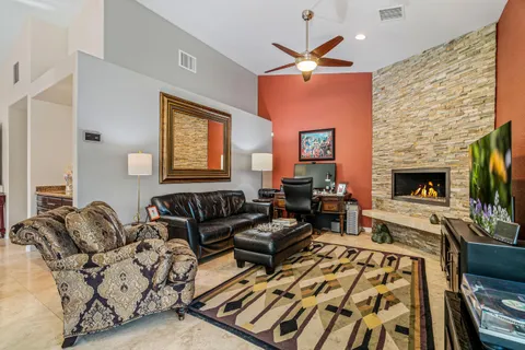 a living room with furniture fireplace and a flat screen tv
