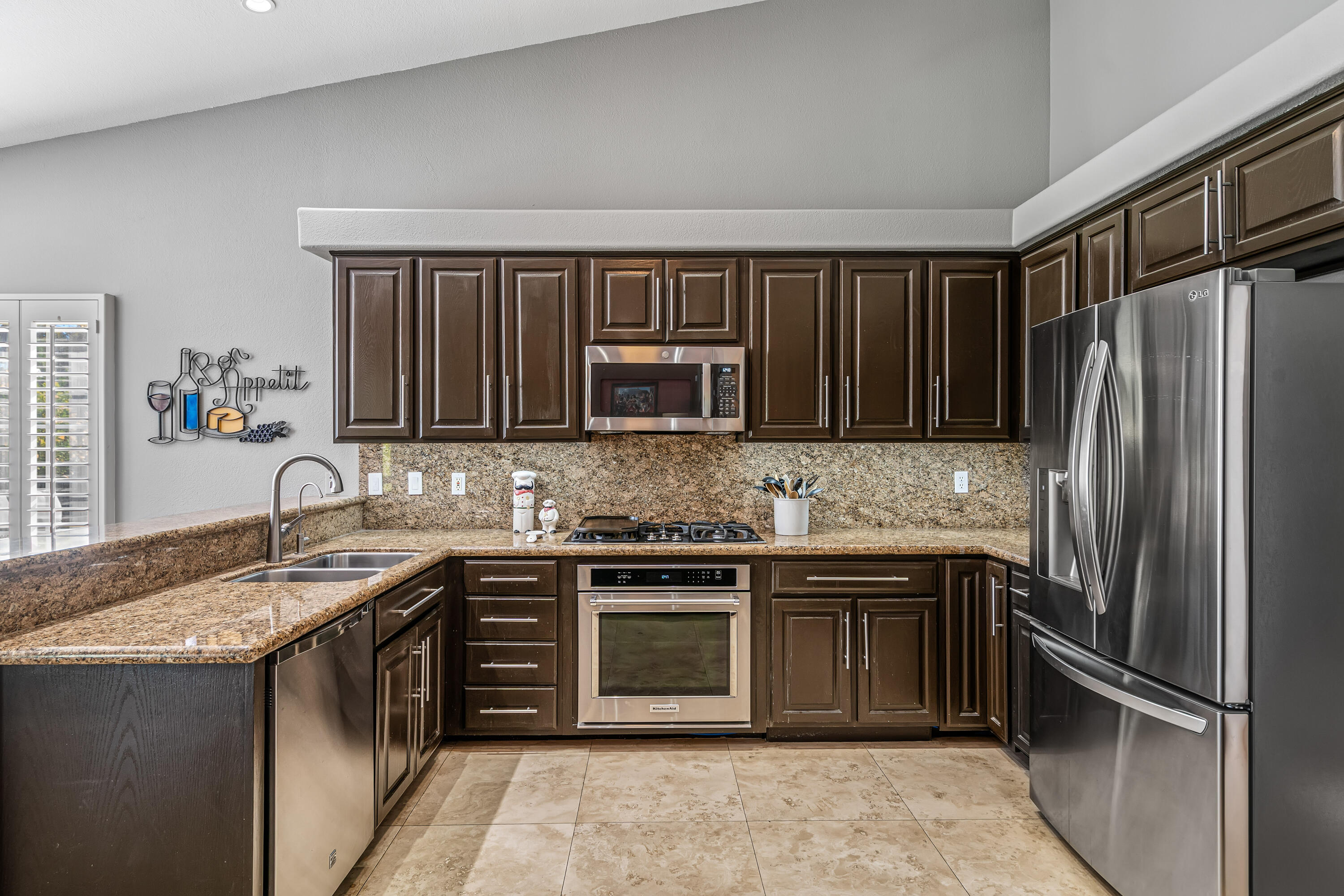 36690 Palm Court Rancho Mirage, CA 92270 - Photo 17 of 54 a kitchen with stainless steel appliances granite countertop a sink stove and refrigerator
