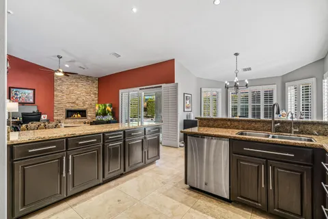 a kitchen with stainless steel appliances granite countertop stove top oven and cabinets
