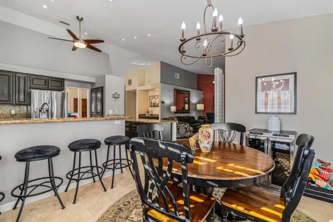 a view of a dining room with furniture and chandelier