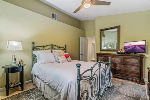 a bedroom with a bed and a lamp