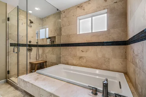 a bathroom with a bathtub and a shower
