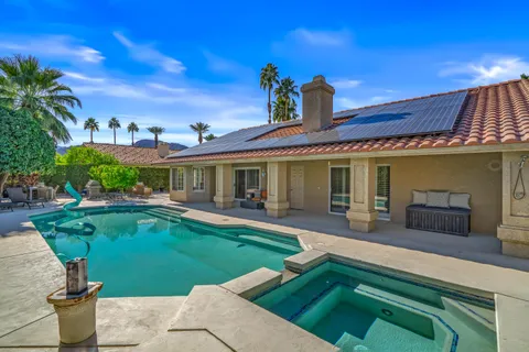a view of a patio with table and chairs and potted plants with wooden fence