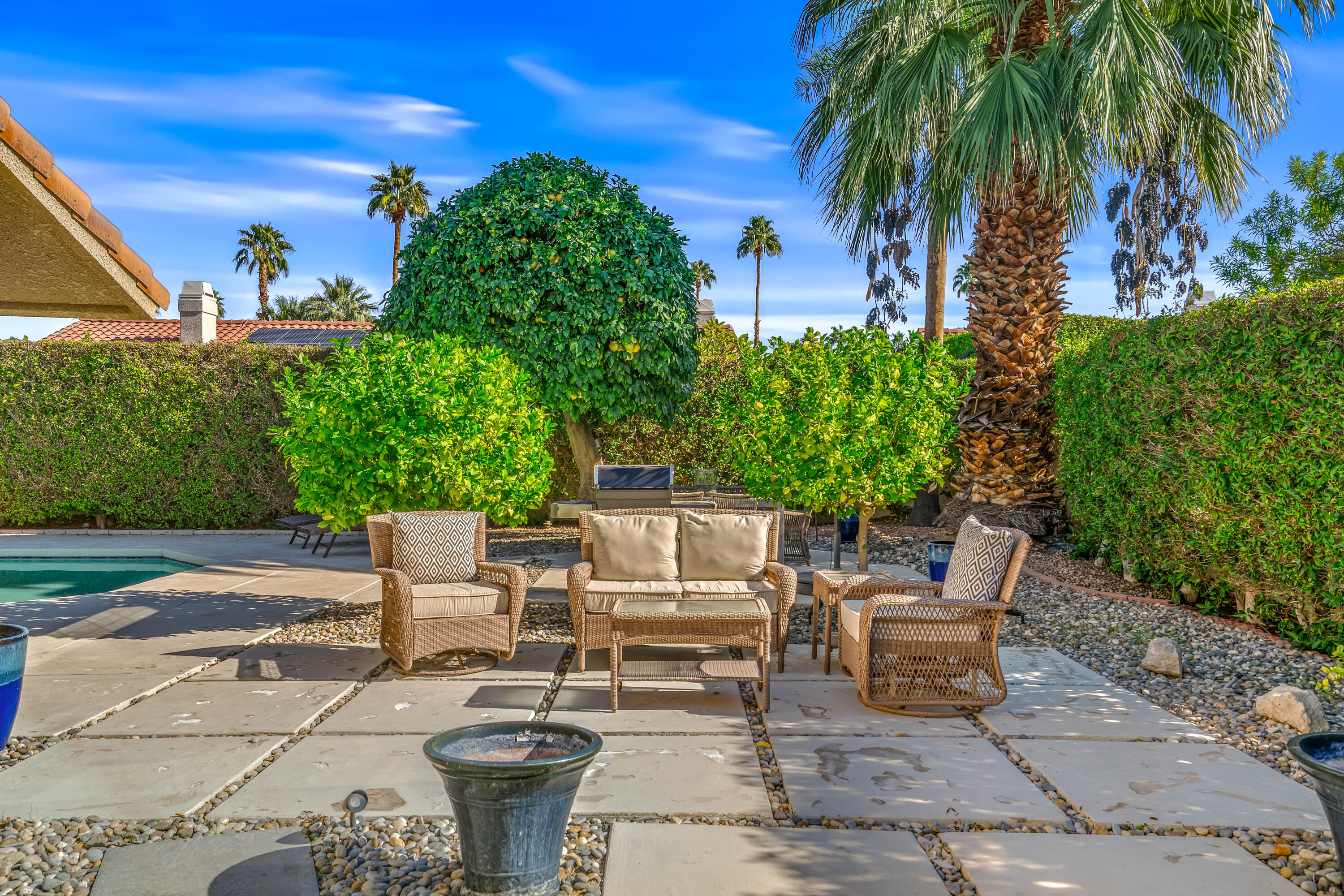 36690 Palm Court Rancho Mirage, CA 92270 - Photo 42 of 54 a view of a patio with table and chairs potted plants and palm tree