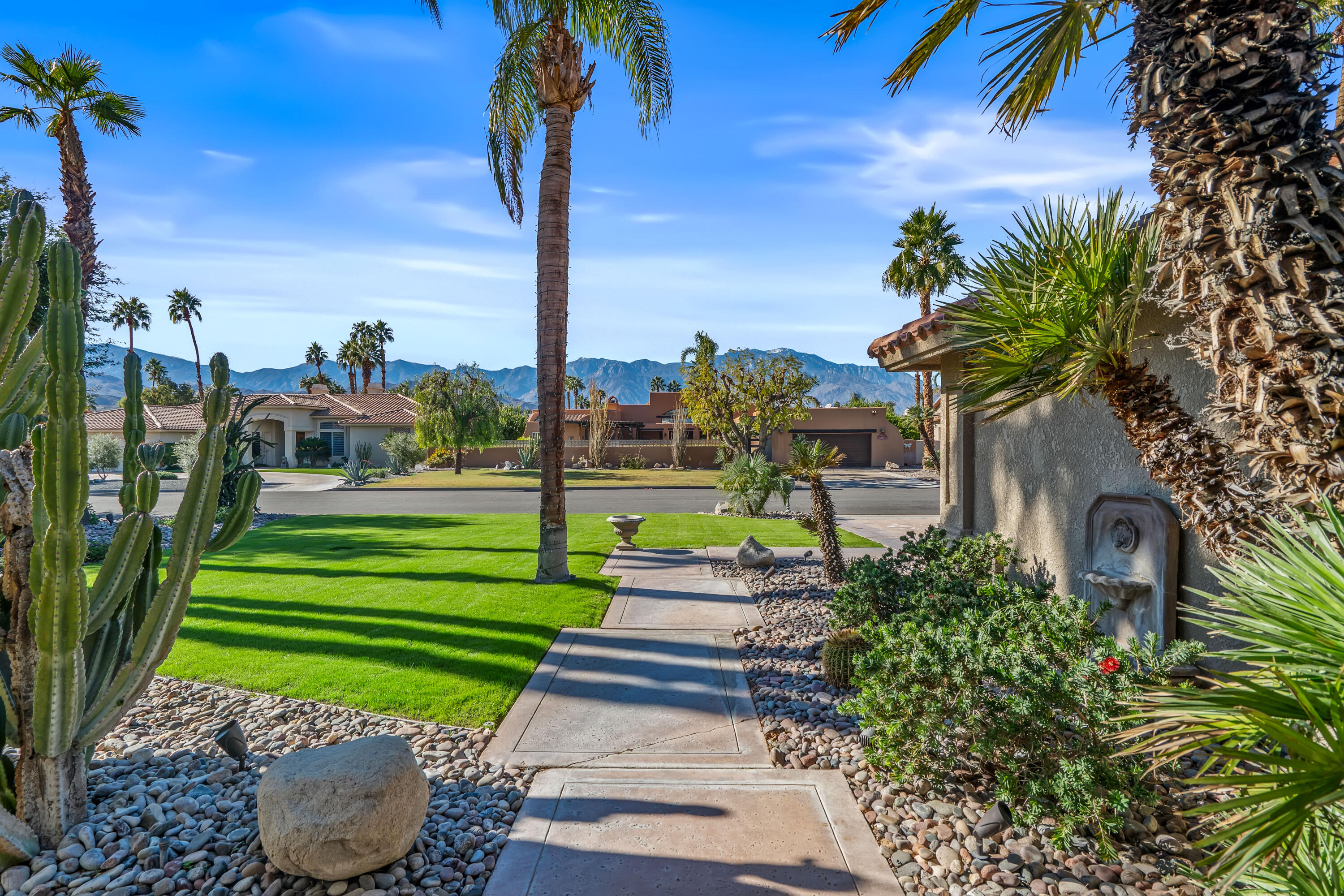 36690 Palm Court Rancho Mirage, CA 92270 - Photo 6 of 54 a green field with lots of flower plants in front of main door