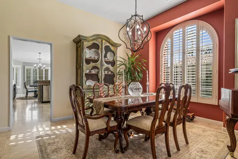 a view of a dining room with furniture wooden floor and chandelier