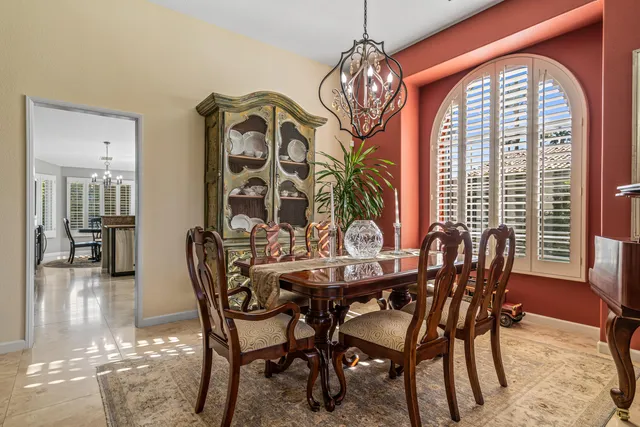 a view of a dining room with furniture wooden floor and chandelier