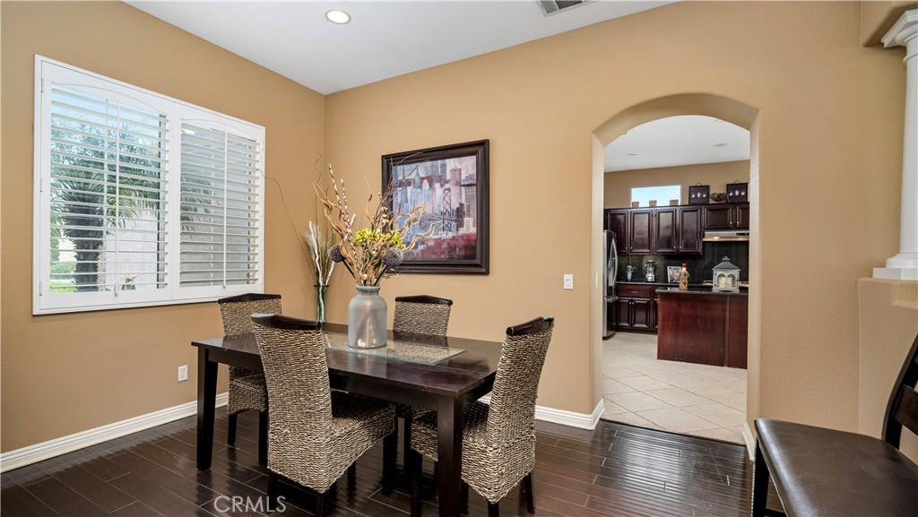 23894 Trail Duster Court Perris, CA 92570 - Photo 16 of 75 a view of a dining room with furniture window and wooden floor
