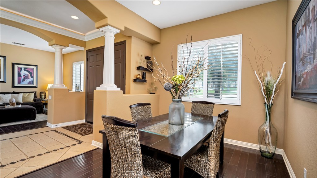23894 Trail Duster Court Perris, CA 92570 - Photo 17 of 75 a view of a dining room with furniture and wooden floor