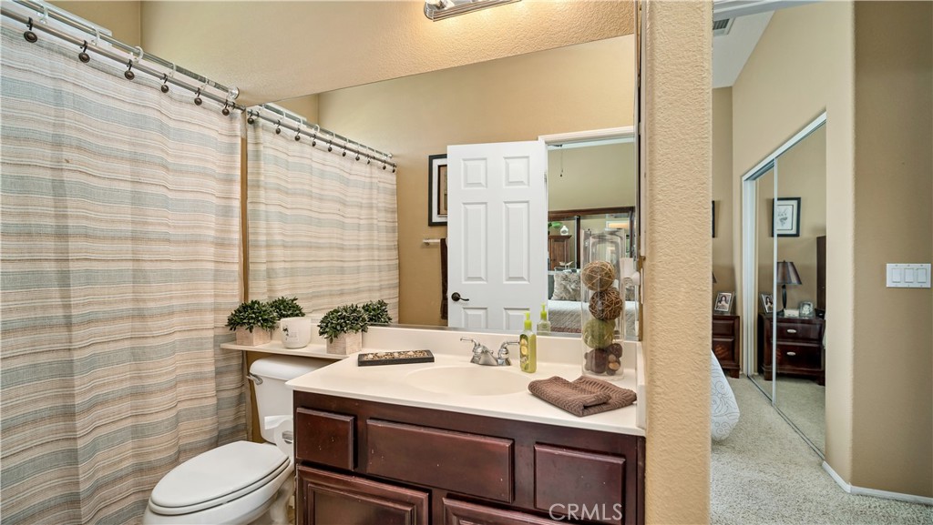 23894 Trail Duster Court Perris, CA 92570 - Photo 27 of 75 a bathroom with a sink toilet vanity and shower
