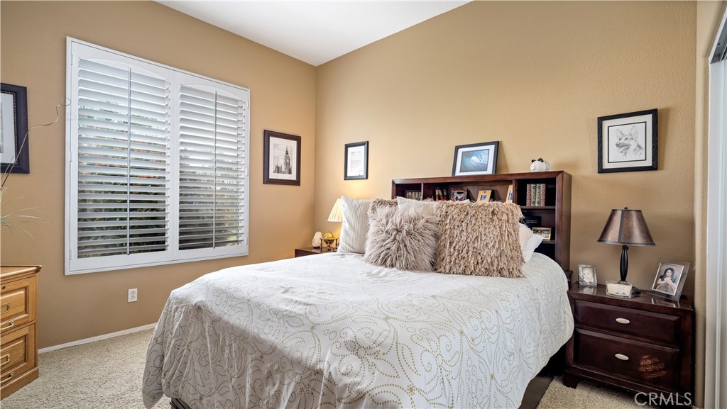 23894 Trail Duster Court Perris, CA 92570 - Photo 28 of 75 a bedroom with a bed and a window