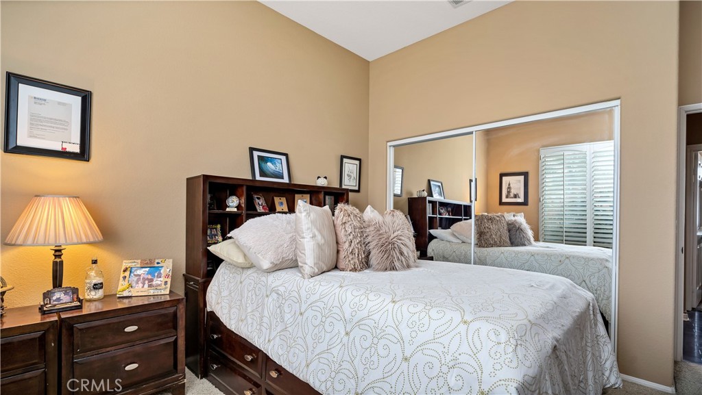 23894 Trail Duster Court Perris, CA 92570 - Photo 29 of 75 a bed room with two bed and a lamp