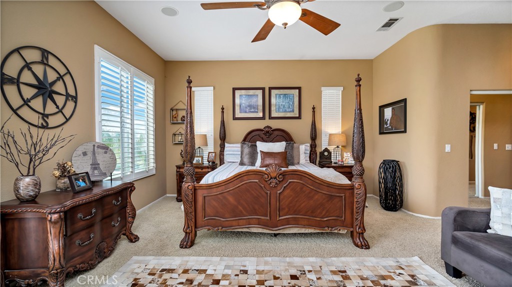 23894 Trail Duster Court Perris, CA 92570 - Photo 38 of 75 a bedroom with a bed and a chandelier