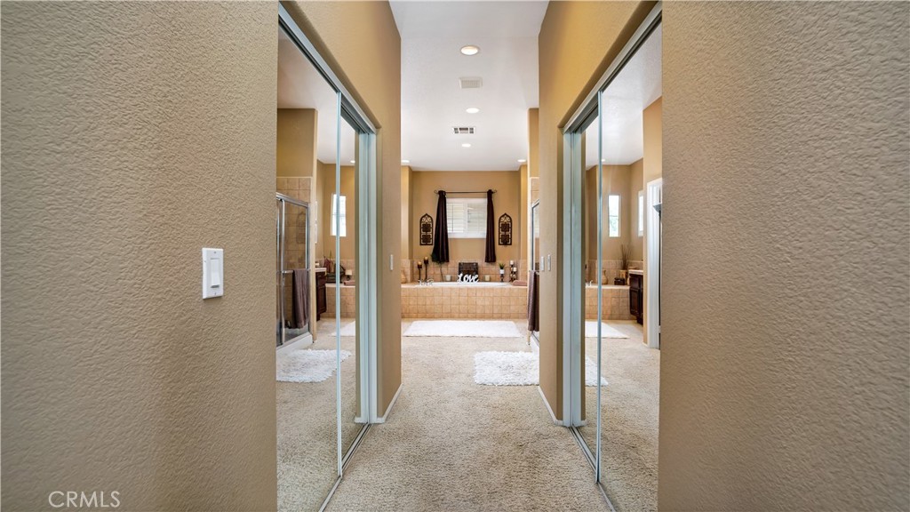 23894 Trail Duster Court Perris, CA 92570 - Photo 42 of 75 a view of a hallway with wooden floor and a bathroom