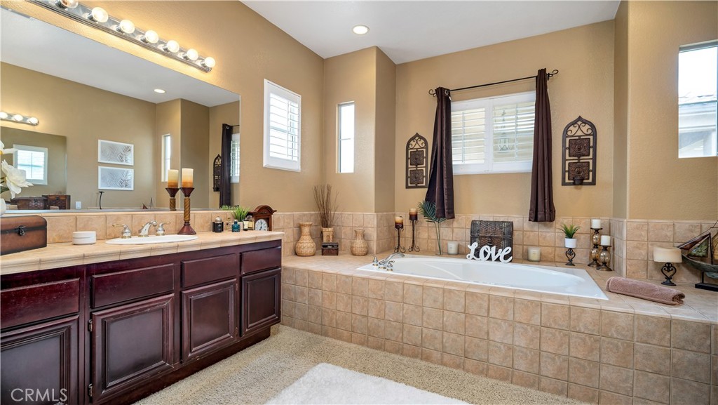 23894 Trail Duster Court Perris, CA 92570 - Photo 45 of 75 a bathroom with double vanity sinks double vanity tub and a mirror