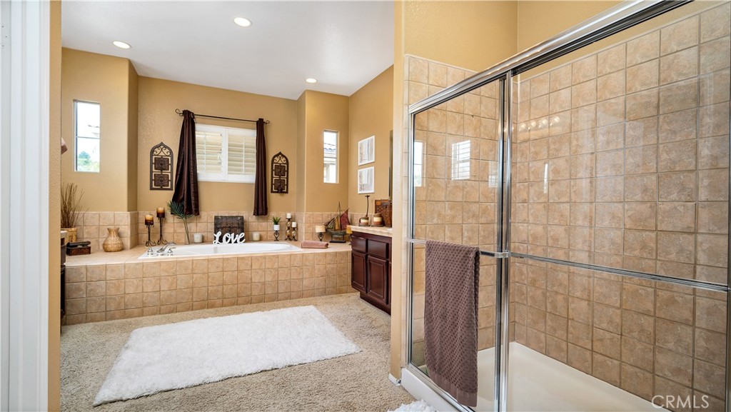 23894 Trail Duster Court Perris, CA 92570 - Photo 46 of 75 a large bathroom with a large tub and shower