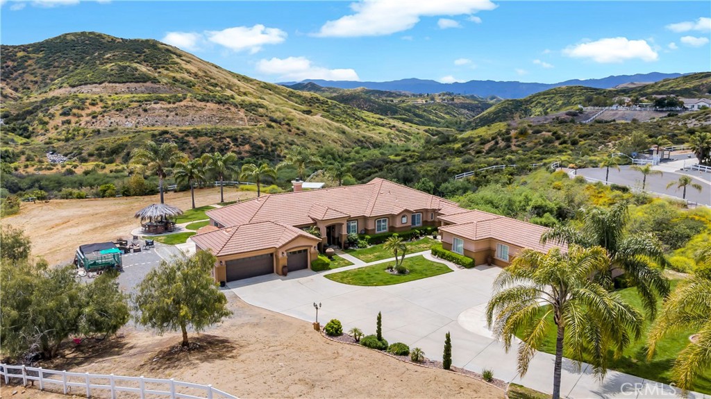 23894 Trail Duster Court Perris, CA 92570 - Photo 5 of 75 a view of a house with a mountain and a garden