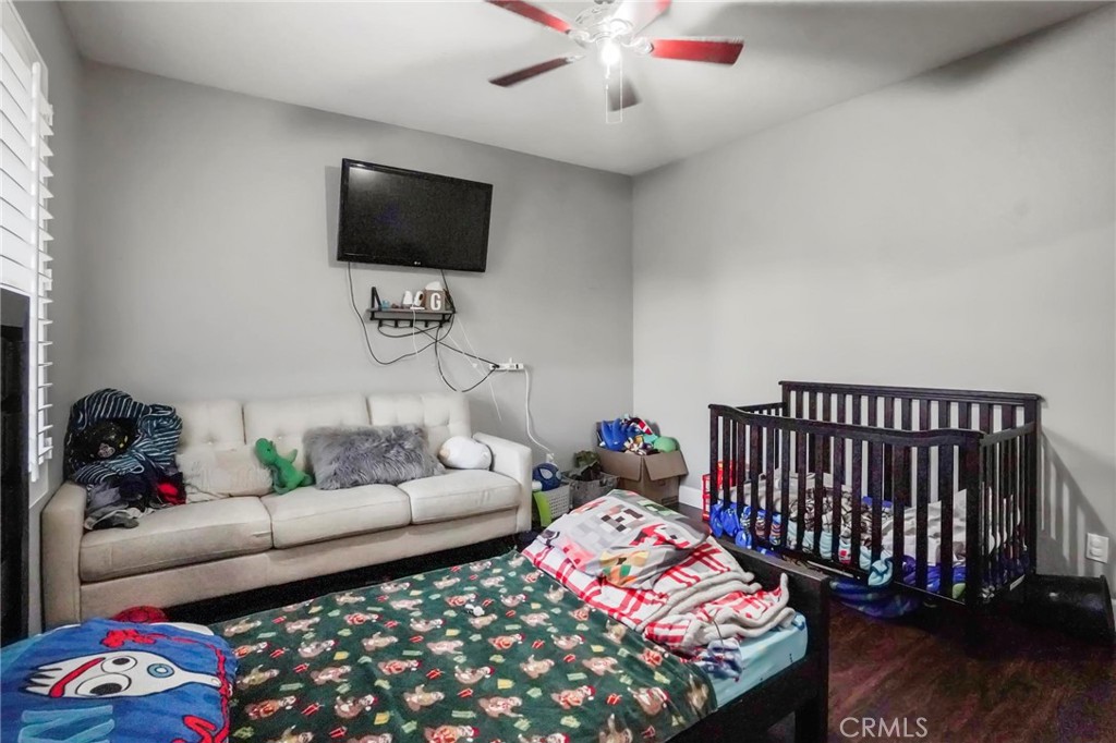 23894 Trail Duster Court Perris, CA 92570 - Photo 67 of 75 a bedroom with furniture and a flat screen tv