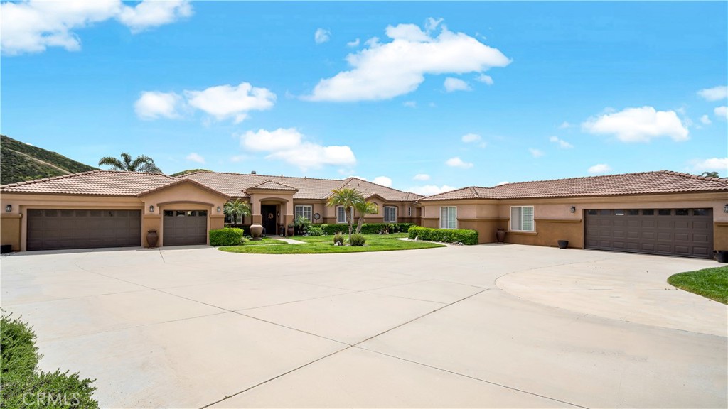 23894 Trail Duster Court Perris, CA 92570 - Photo 7 of 75 a front view of a house with a yard and garage