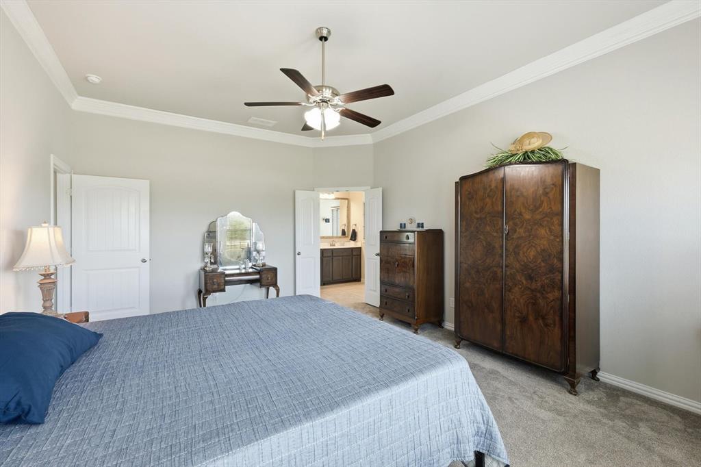 113 Heather Lane Decatur, TX 76234 - Photo 16 of 32 a bed room with a bed and a ceiling fan