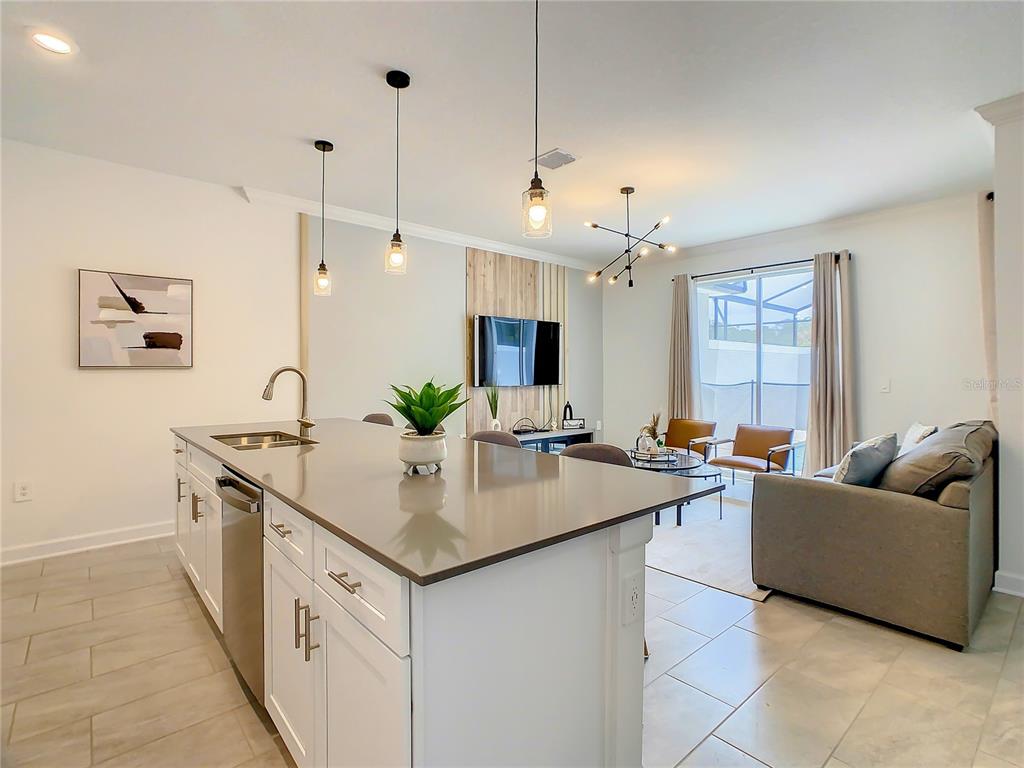 2573 Reading Trail Kissimmee, FL 34746 - Photo 12 of 54 a view of kitchen island a sink and living room view