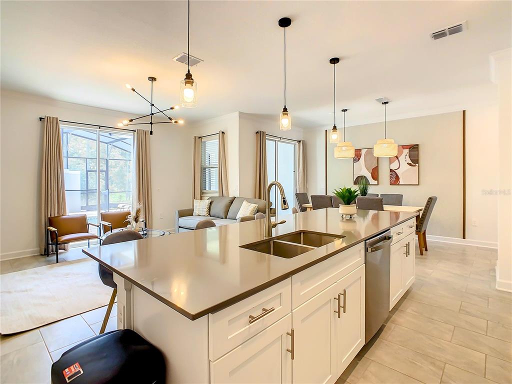 2573 Reading Trail Kissimmee, FL 34746 - Photo 17 of 54 a kitchen with a stove center island and couches