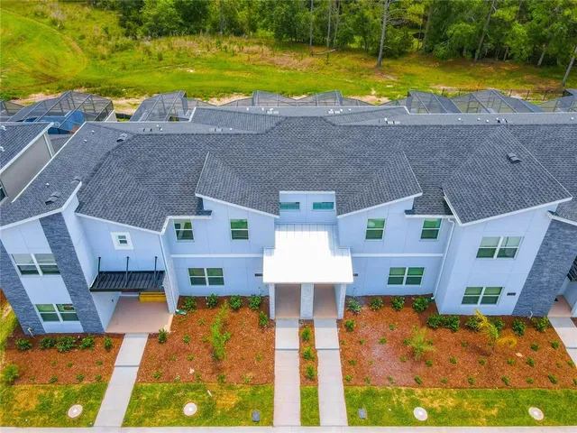 an aerial view of residential houses with swimming pool