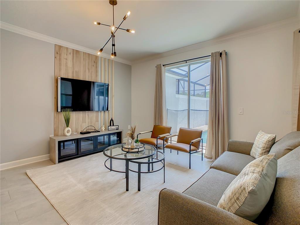 2573 Reading Trail Kissimmee, FL 34746 - Photo 21 of 54 a living room with furniture and a flat screen tv
