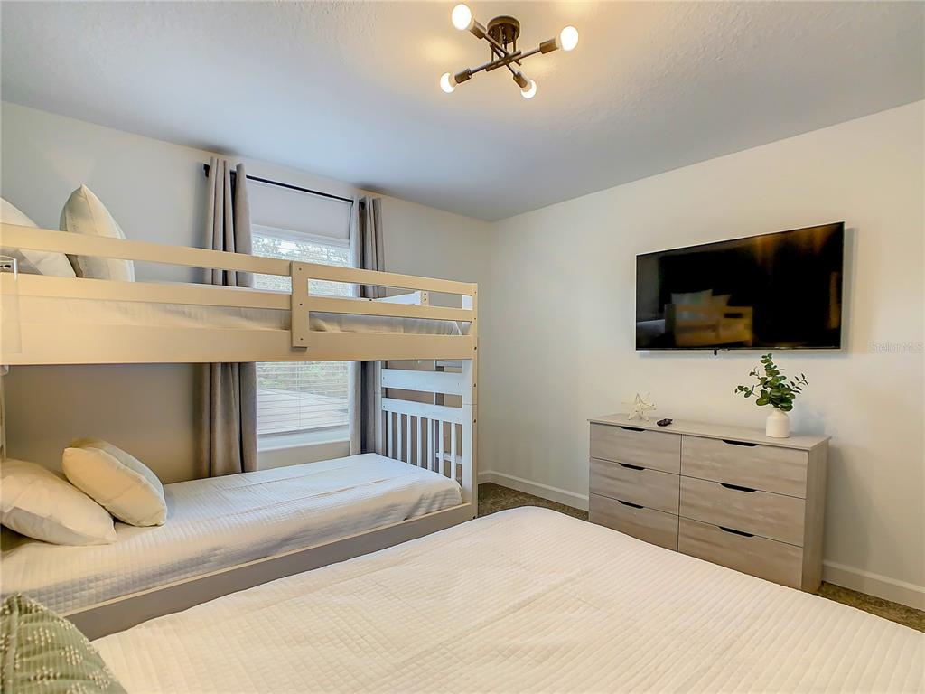 2573 Reading Trail Kissimmee, FL 34746 - Photo 26 of 54 a bedroom with a bed and flat screen tv