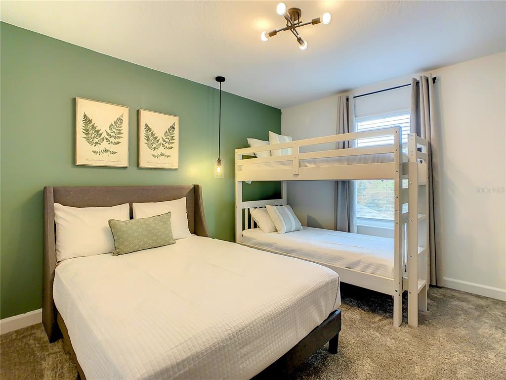 2573 Reading Trail Kissimmee, FL 34746 - Photo 27 of 54 a bedroom with a bed and a table