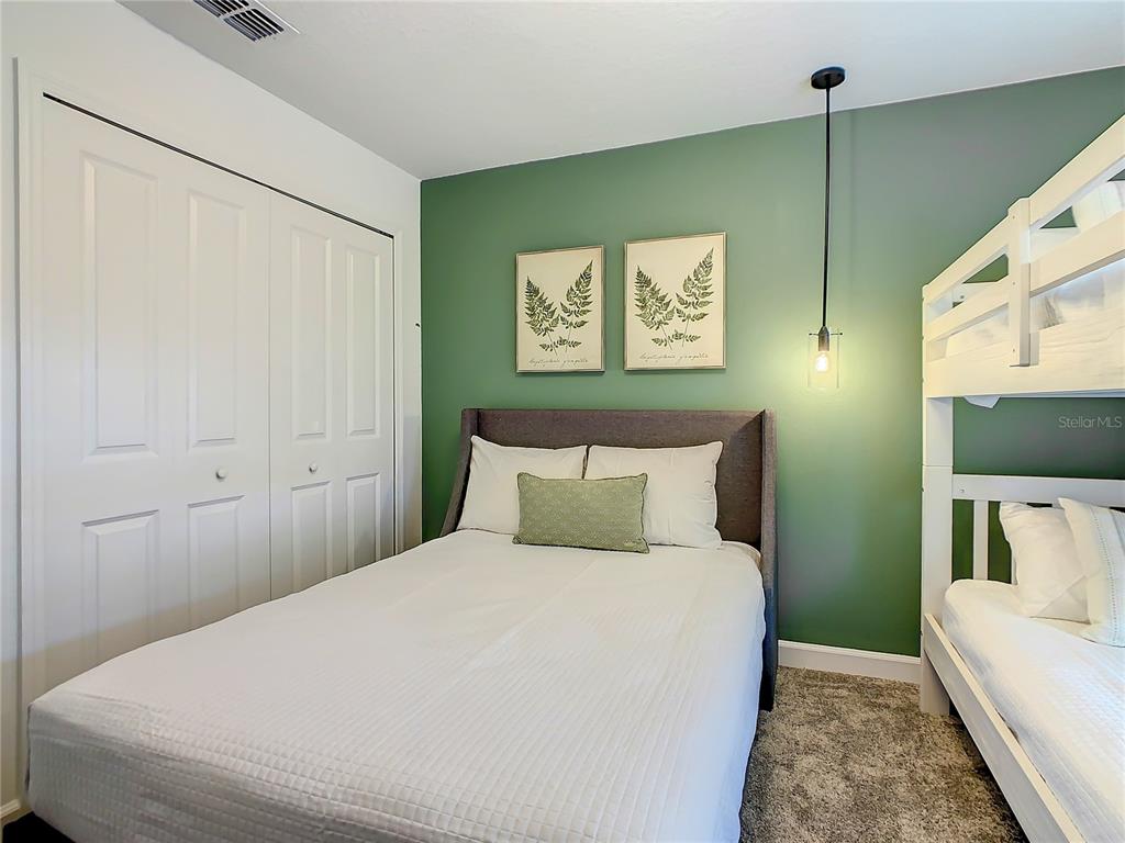 2573 Reading Trail Kissimmee, FL 34746 - Photo 28 of 54 a bedroom with a bed and a flat screen tv