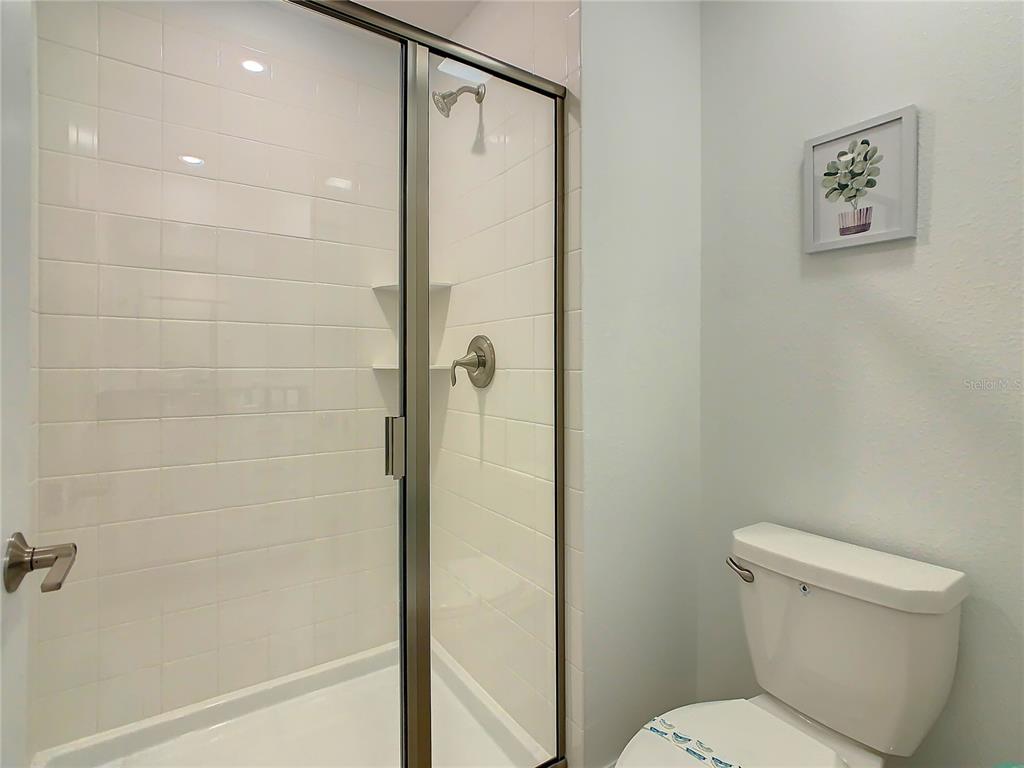 2573 Reading Trail Kissimmee, FL 34746 - Photo 30 of 54 a bathroom with a toilet and a shower