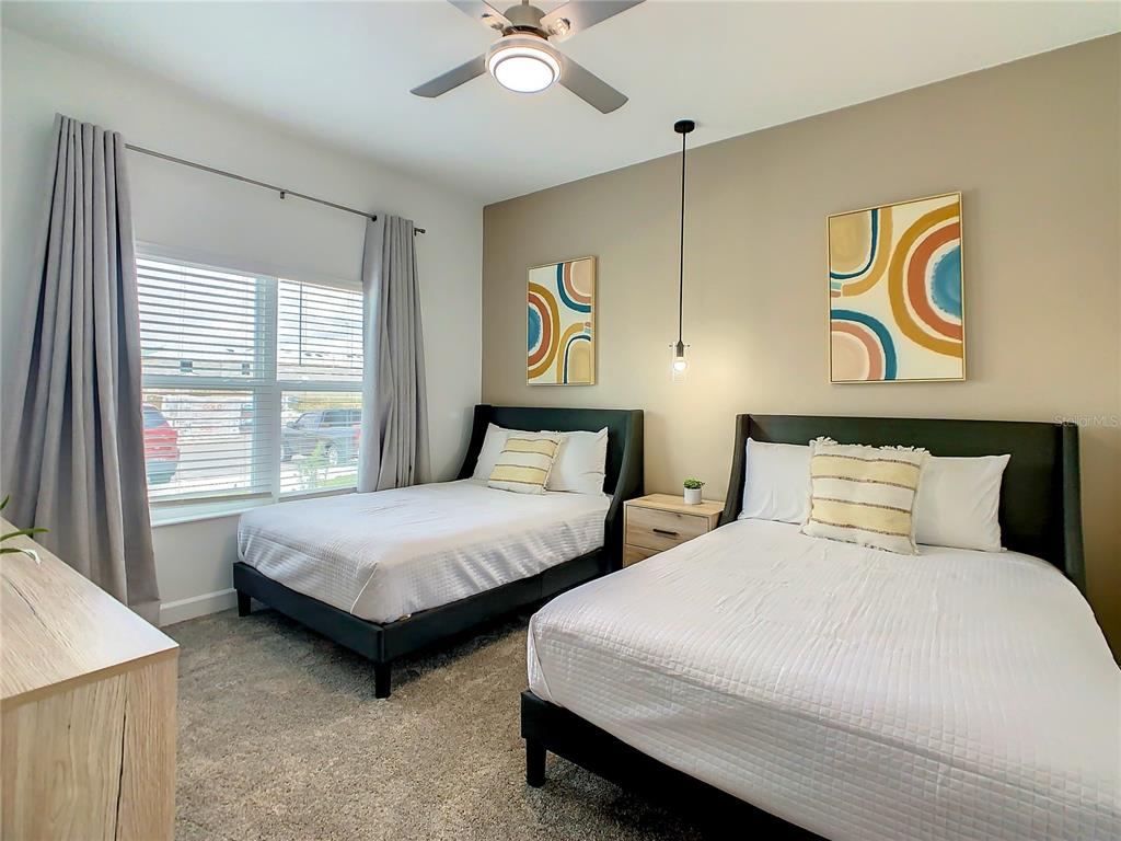 2573 Reading Trail Kissimmee, FL 34746 - Photo 38 of 54 a bedroom with two beds and painting on the wall