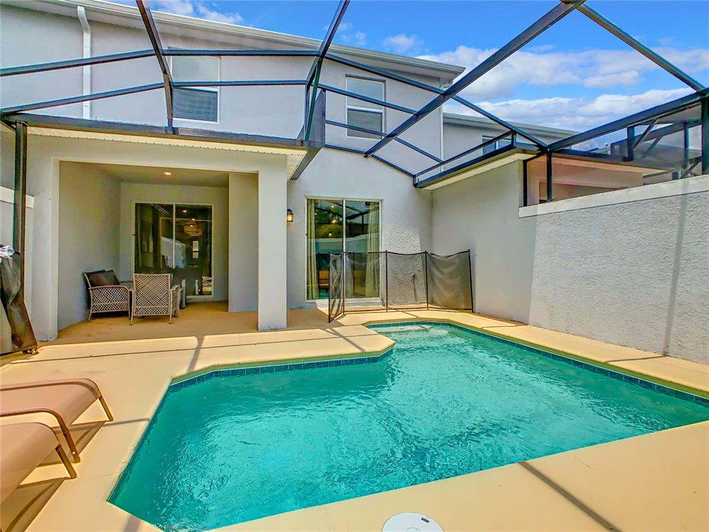 2573 Reading Trail Kissimmee, FL 34746 - Photo 49 of 54 a view of a backyard with pool table and chairs