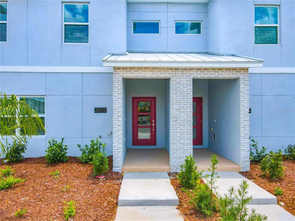 2573 Reading Trail Kissimmee, FL 34746 - Photo 6 of 54 a front view of a house with garden