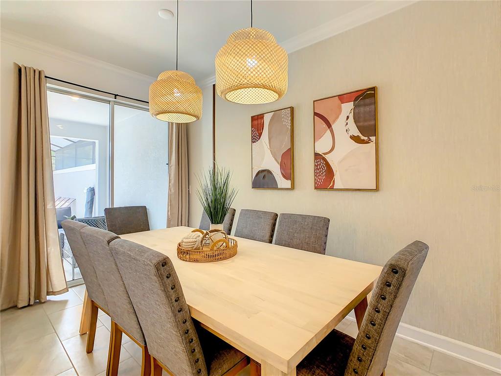 2573 Reading Trail Kissimmee, FL 34746 - Photo 9 of 54 a view of a dining room with furniture and wooden floor