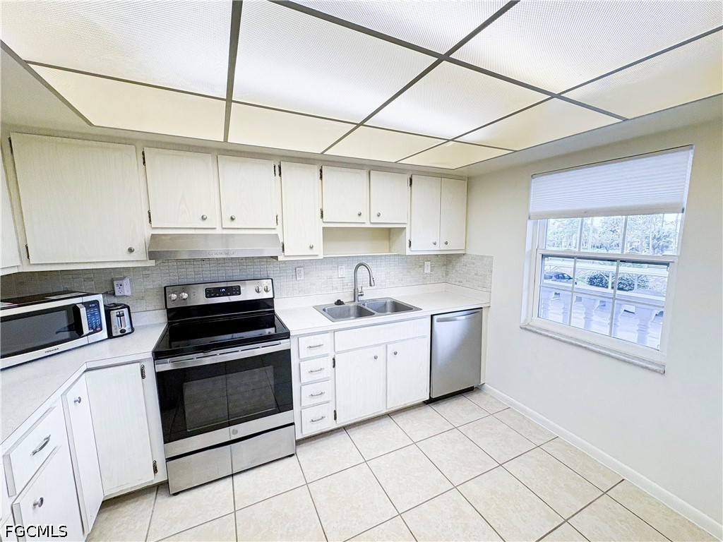 1830 Brantley Road, Unit I7 Fort Myers, FL 33907 - Photo 5 of 34 a kitchen with cabinets stainless steel appliances and a counter