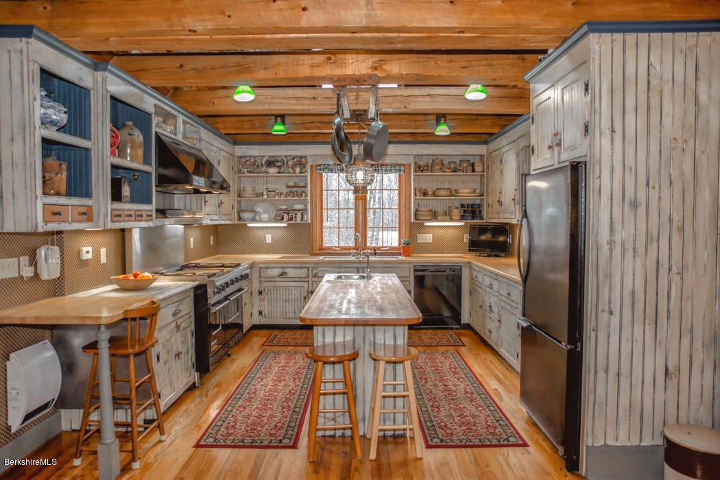 99 Kibbe Road Otis, MA 01029 - Photo 21 of 58 a kitchen with stainless steel appliances granite countertop a stove a sink and a refrigerator