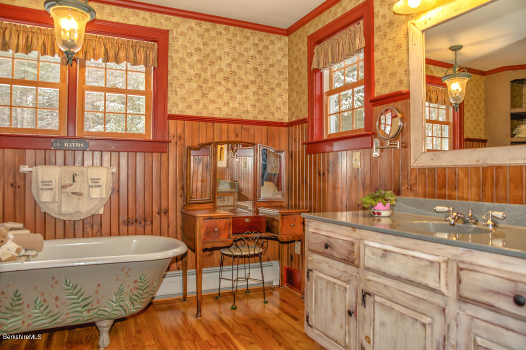 99 Kibbe Road Otis, MA 01029 - Photo 34 of 58 a bathroom with a granite countertop tub sink and mirror