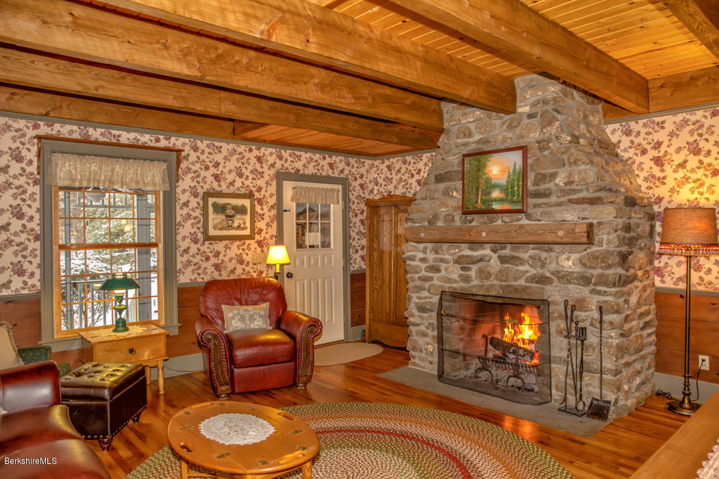 99 Kibbe Road Otis, MA 01029 - Photo 36 of 58 a living room with furniture and a fireplace