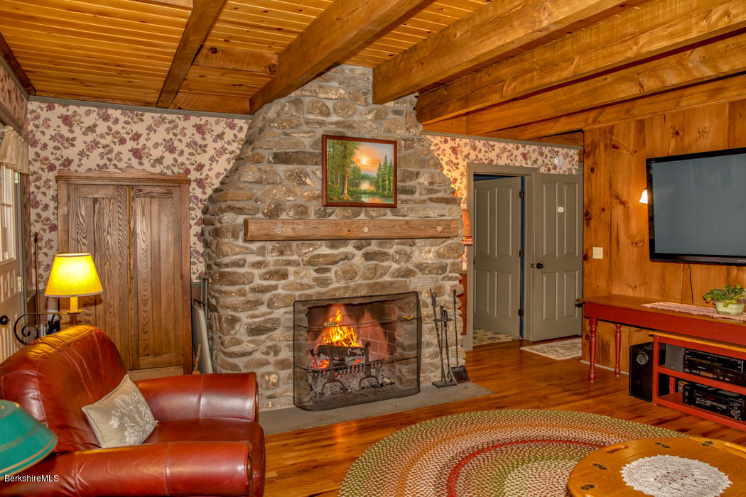 99 Kibbe Road Otis, MA 01029 - Photo 37 of 58 a living room with furniture and a fireplace