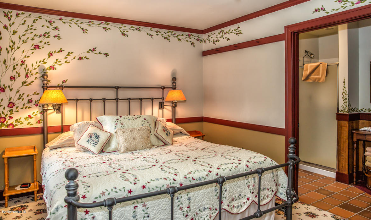 99 Kibbe Road Otis, MA 01029 - Photo 40 of 58 a bedroom with a bed and wooden floor