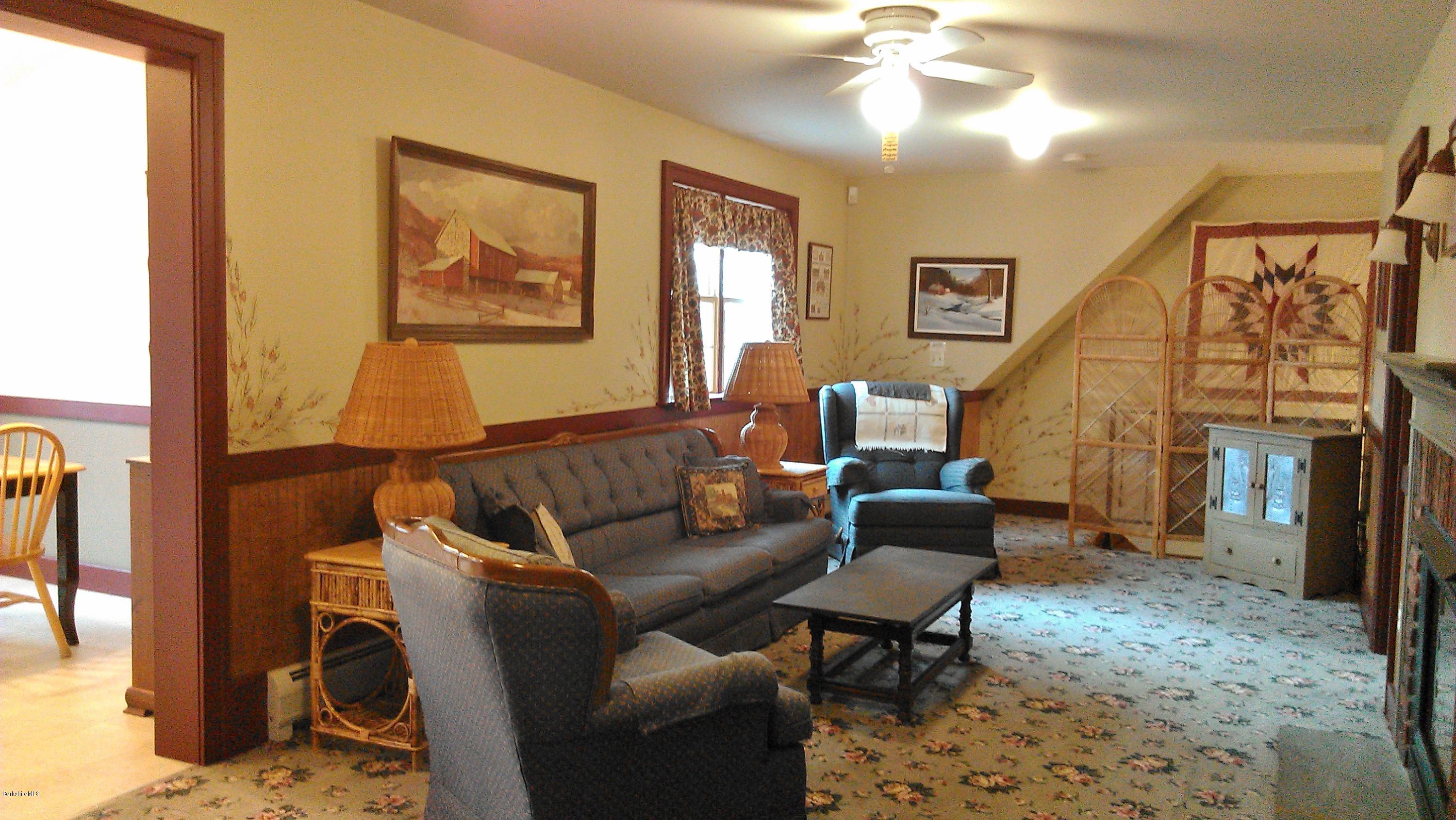 99 Kibbe Road Otis, MA 01029 - Photo 55 of 58 a living room with furniture and a fireplace