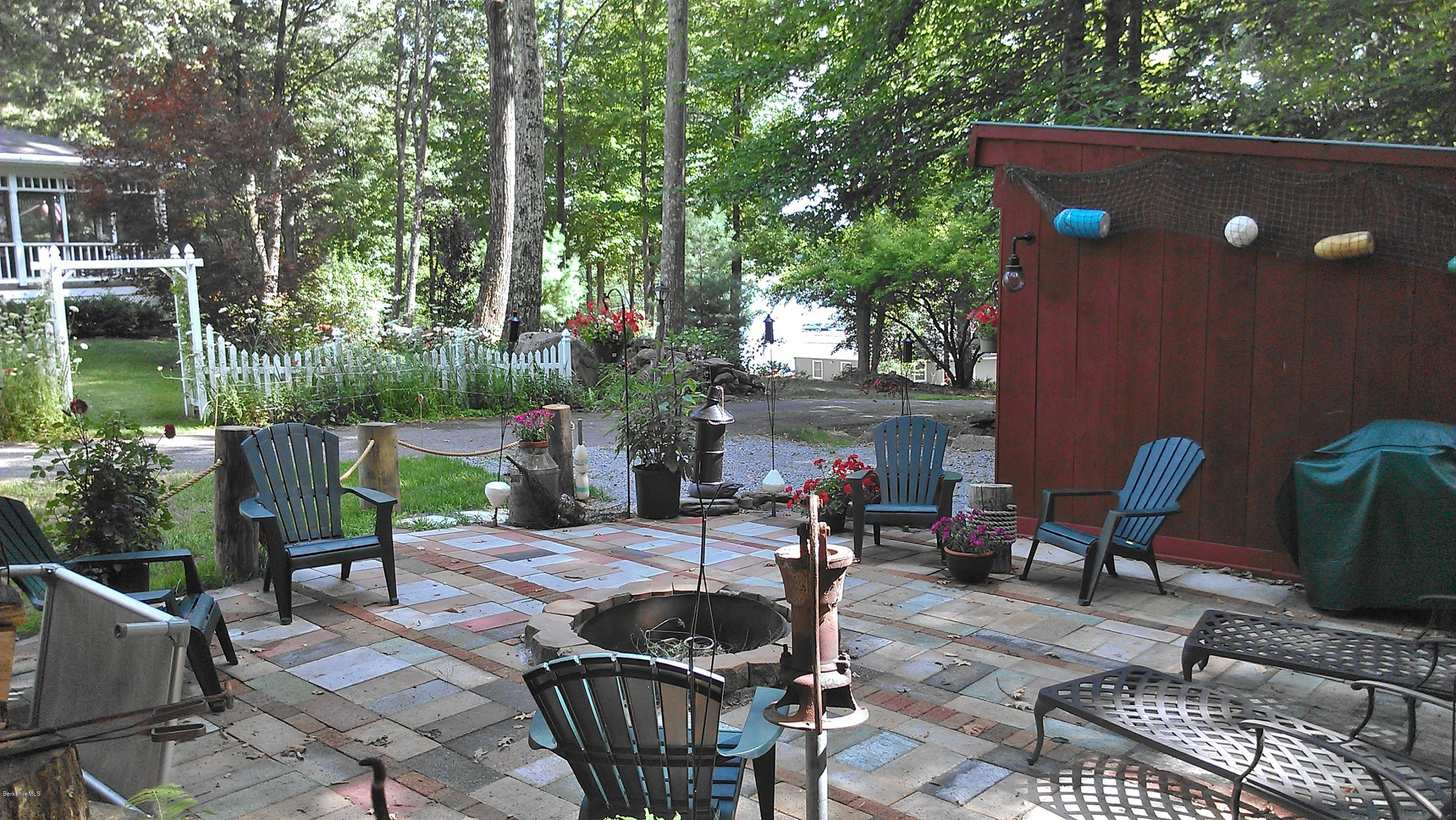 99 Kibbe Road Otis, MA 01029 - Photo 7 of 58 a view of a chairs and tables in the patio