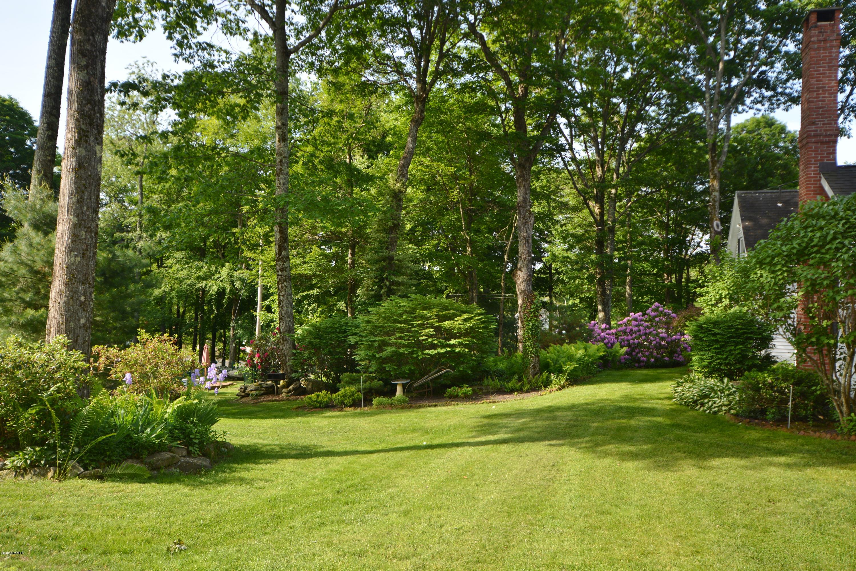 99 Kibbe Road Otis, MA 01029 - Photo 9 of 58 a view of a fountain in front of a house