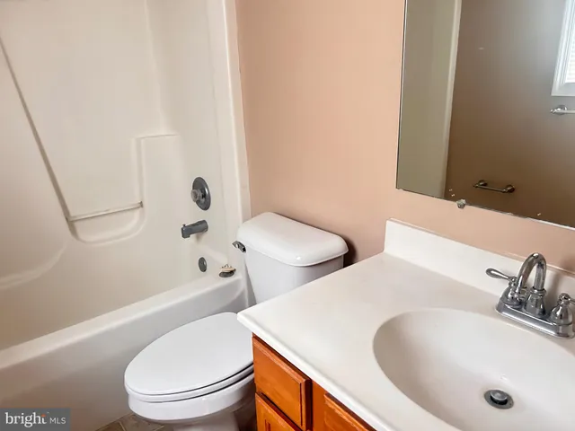 a bathroom with a toilet a sink and bathtub