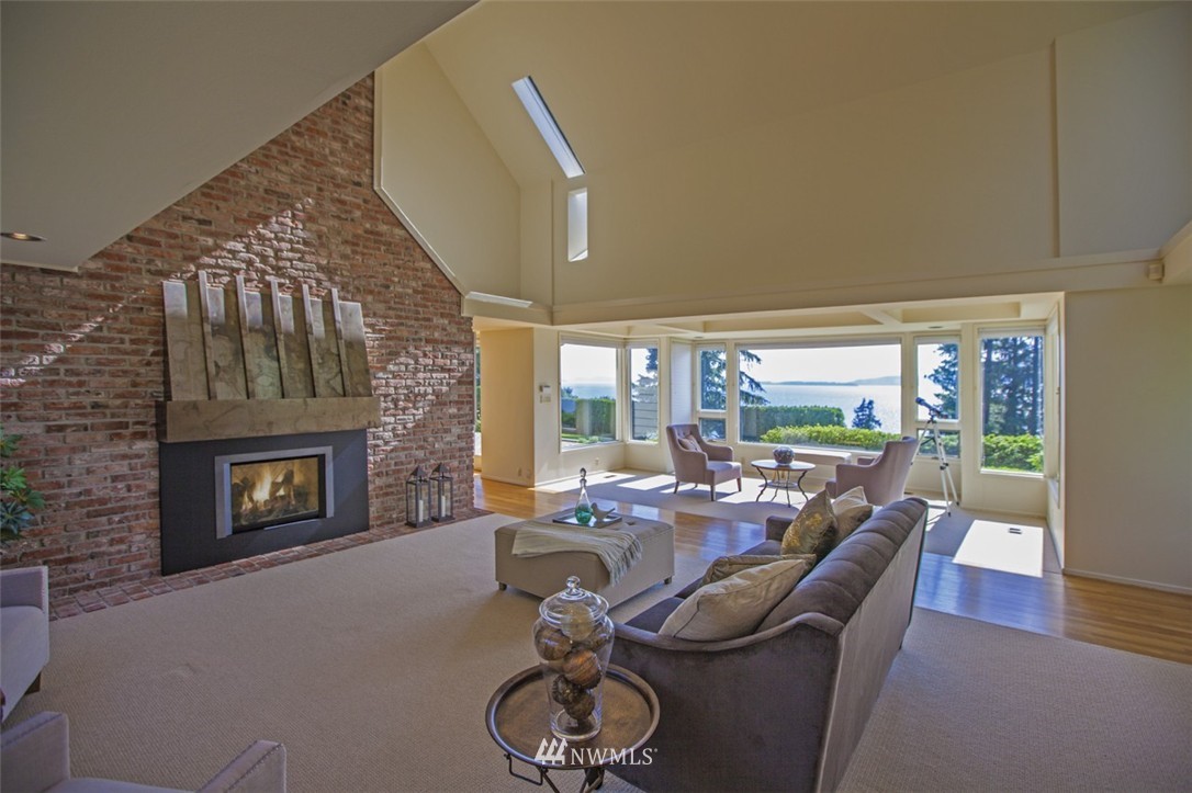 294 Briar Road Bellingham, WA 98225 - Photo 13 of 25 a living room with furniture a fireplace and a floor to ceiling window