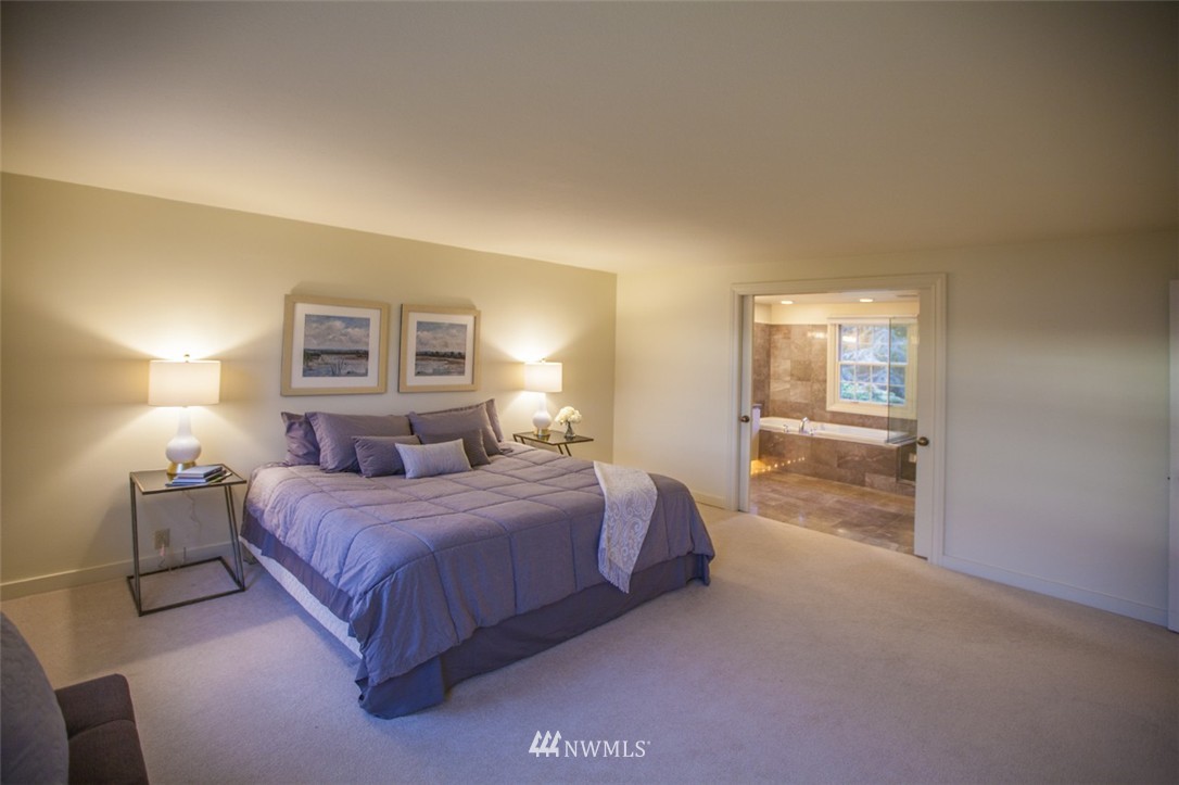 294 Briar Road Bellingham, WA 98225 - Photo 21 of 25 a spacious bedroom with a bed and a lamp