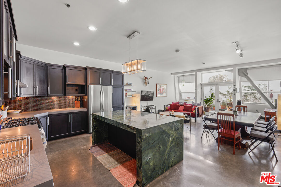 a large kitchen with a large counter top appliances and cabinets